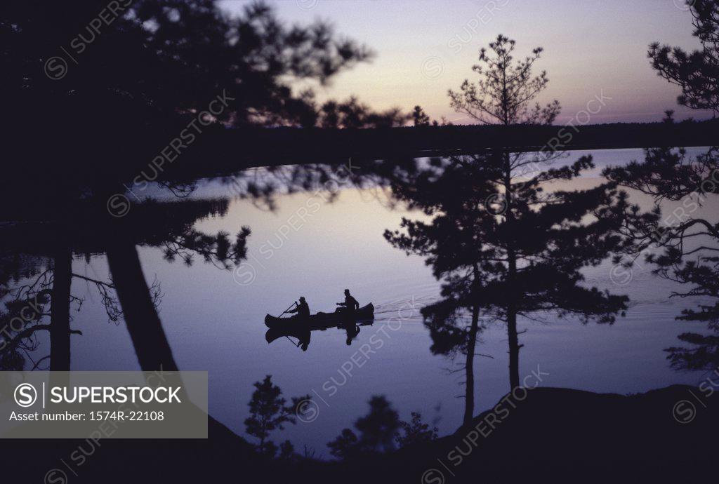 Stock Photo: 1574R-22108 Silhouette of two people in a canoe, Canada