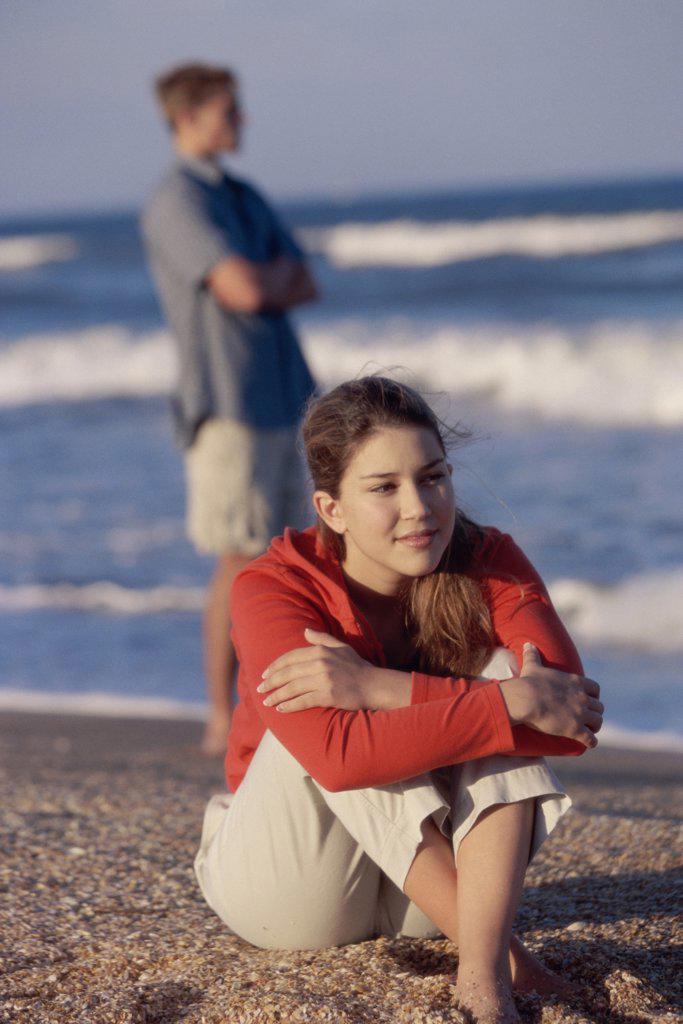 Close-up of a teenage girl sitting on the beach