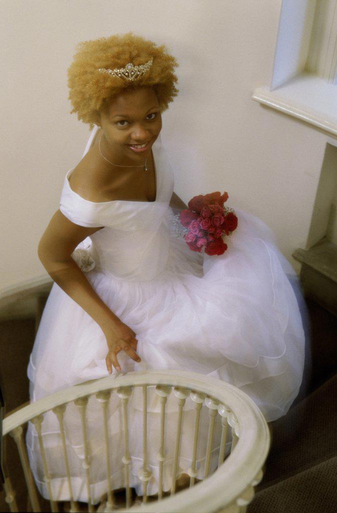 High angle view of a newlywed woman walking up stairs