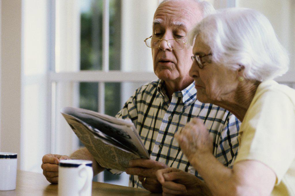 Senior couple reading a newspaper together