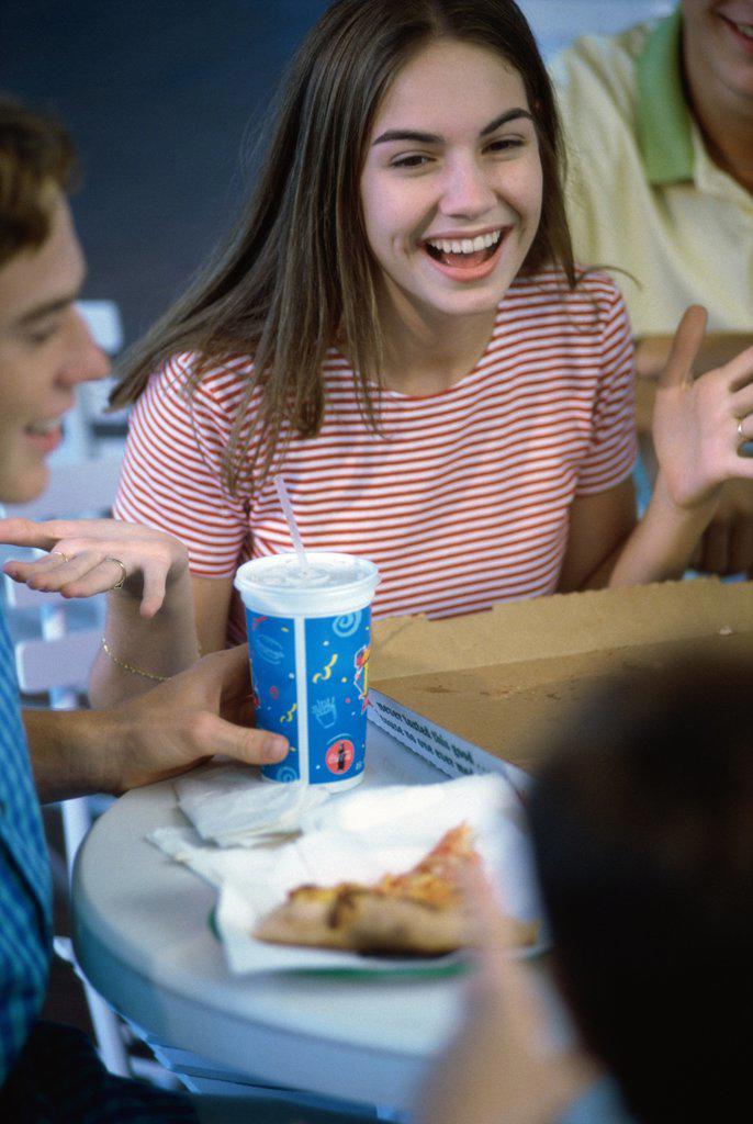 High angle view of a teenage girl smiling in a restaurant