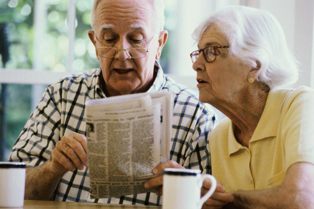 Senior couple reading a newspaper together