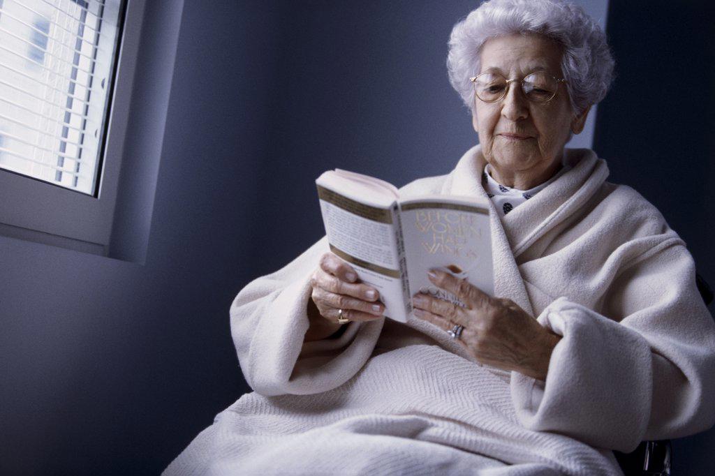 Close-up of a senior woman reading a book