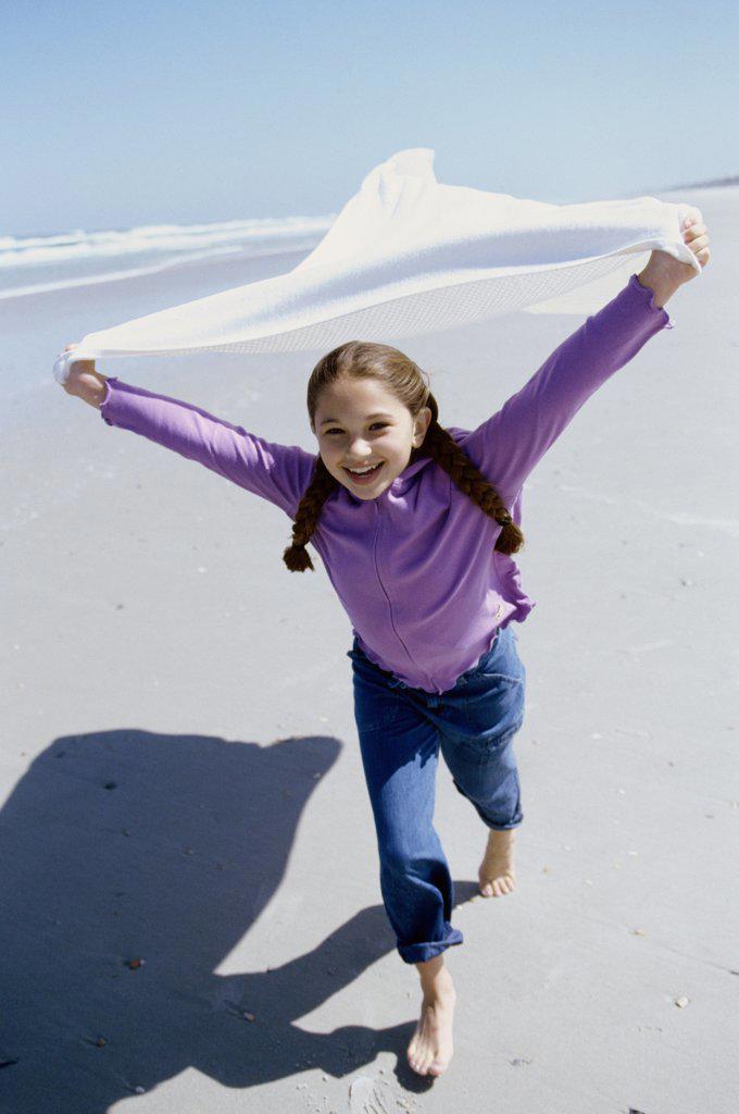 Portrait of a girl running on the beach
