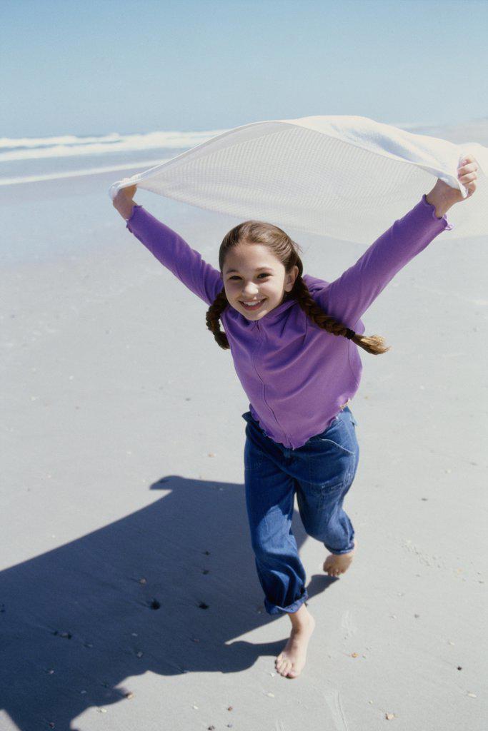 Portrait of a girl running on the beach