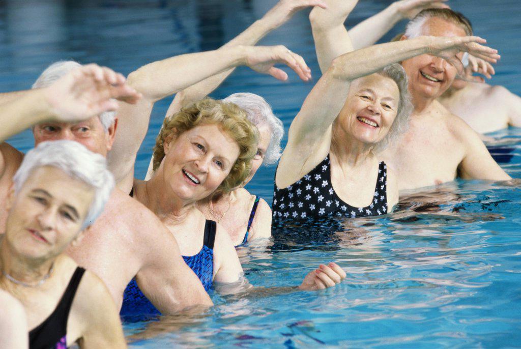 Group of senior people performing water aerobics in a swimming pool