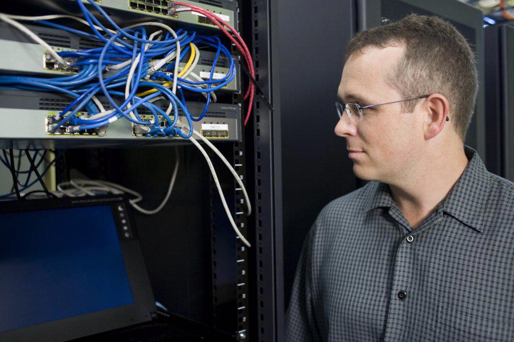 Close-up of a technician looking at a network server