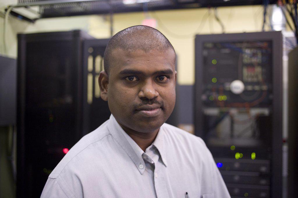 Portrait of a technician standing in a server room