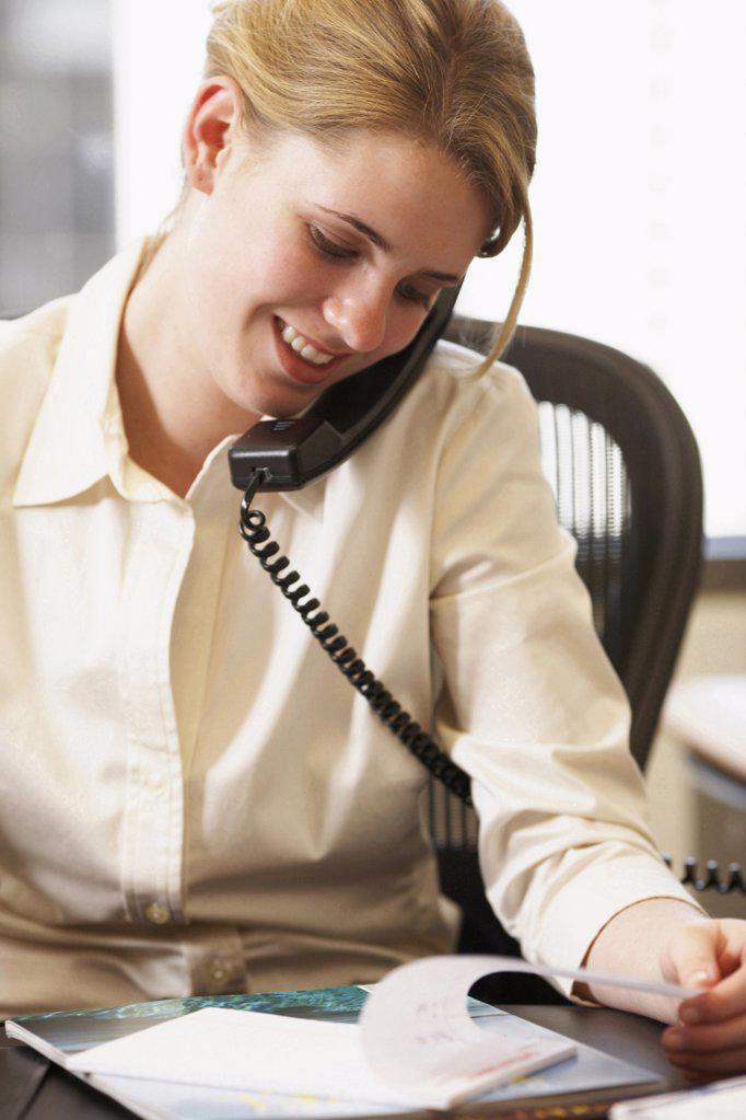 Close-up of a businesswoman talking on the telephone in an office