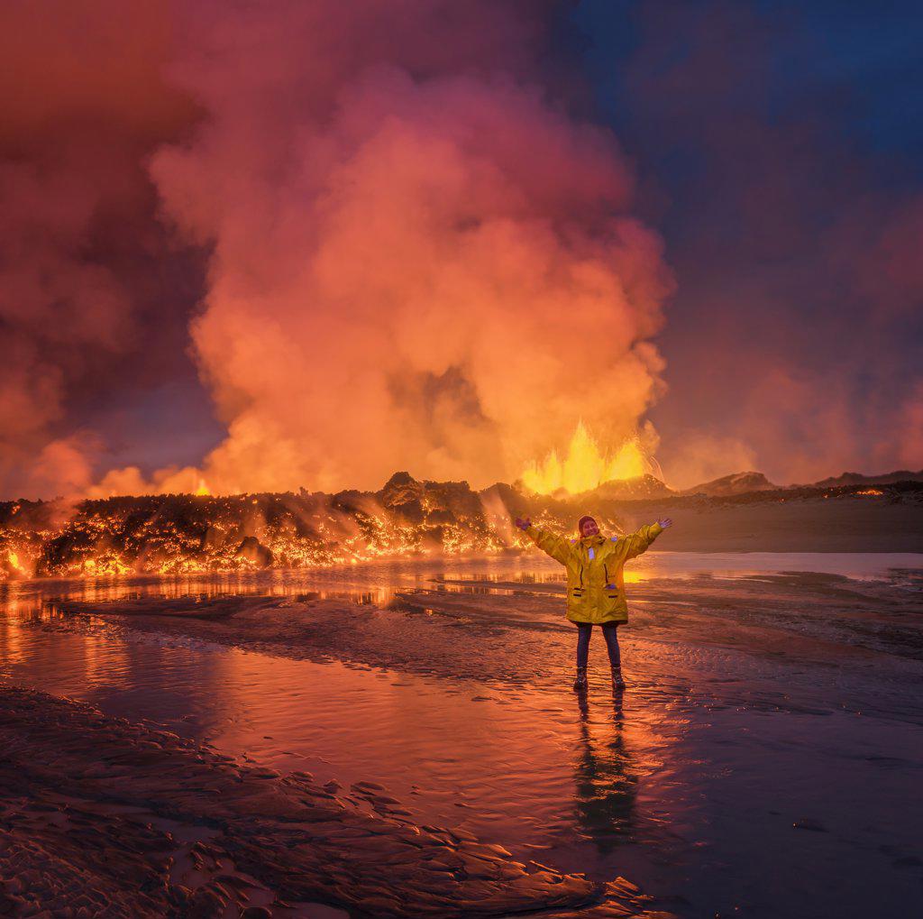 Woman standing by glowing lava. August 29, 2014, a fissure eruption started in Holuhraun at the northern end of a magma intrusion, which had moved progressively north, from the Bardarbunga volcano. Bardarbunga is a stratovolcano located under Vatnajokull, Icelands most extensive glacier. Picture date- Sept 2, 2014