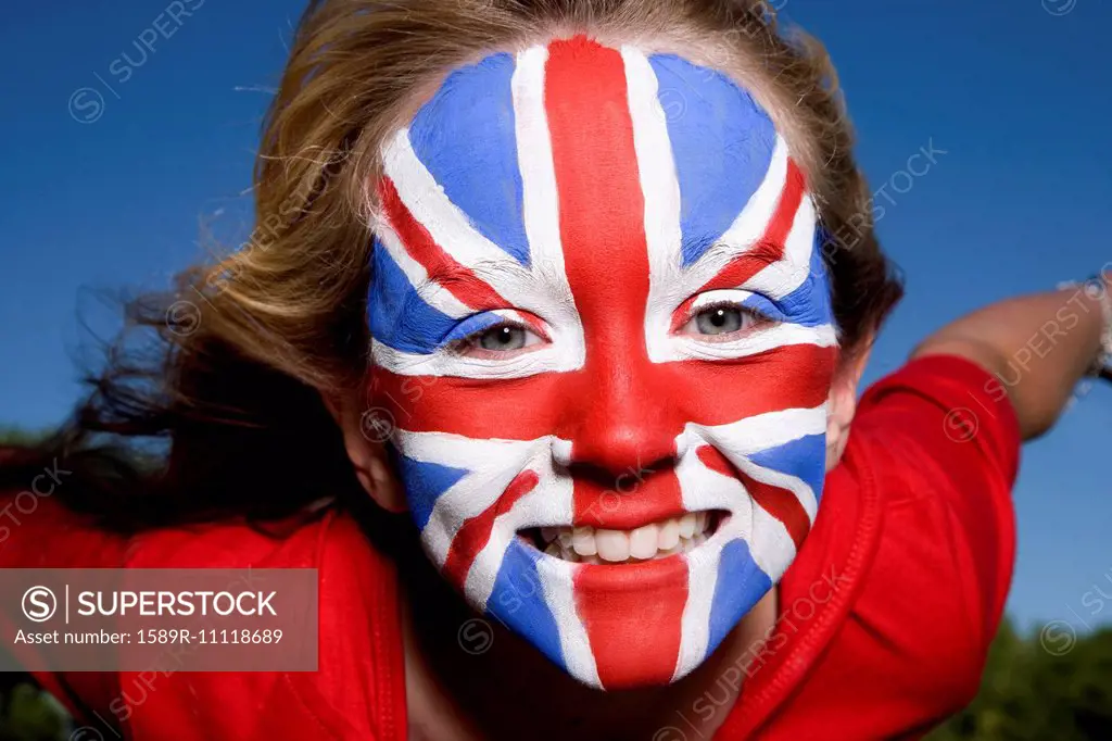 Caucasian girl with United Kingdom flag painted on face