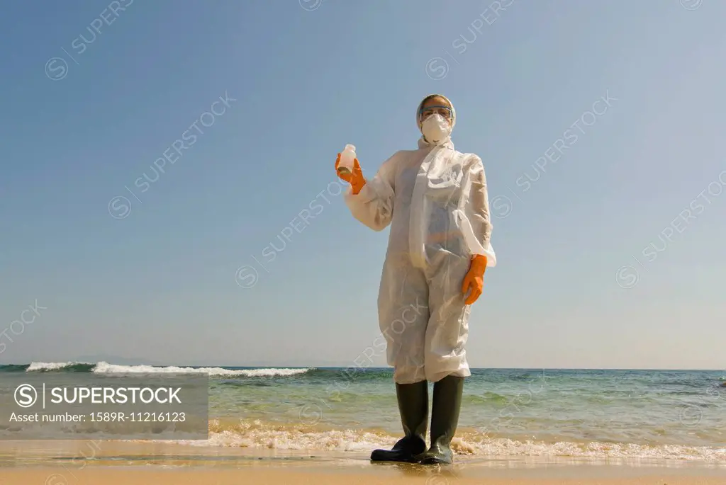 Woman in full-body protective clothing on beach