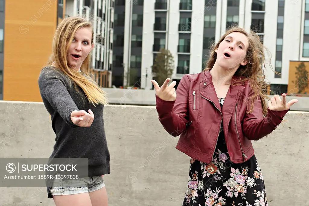 Teenage girls posing on urban rooftop