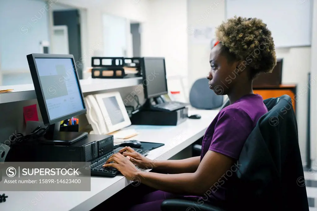 Black nurse using computer