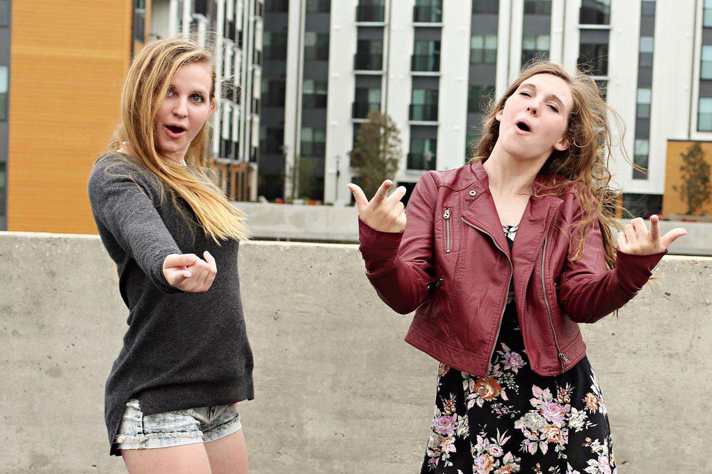 Teenage girls posing on urban rooftop