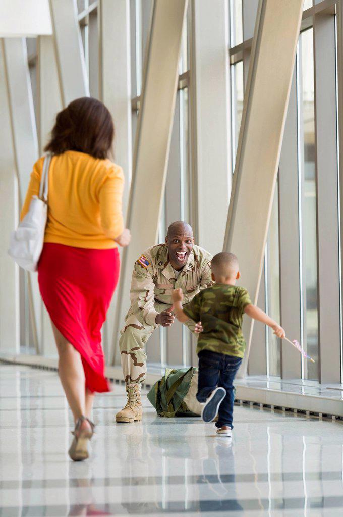 African American soldier greeting family in airport