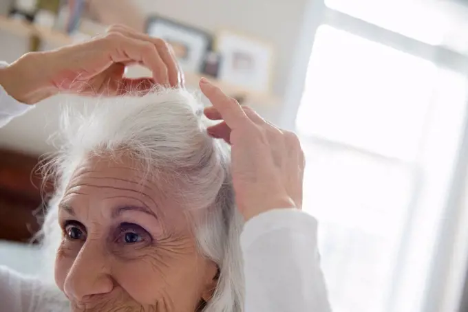Older woman arranging hair
