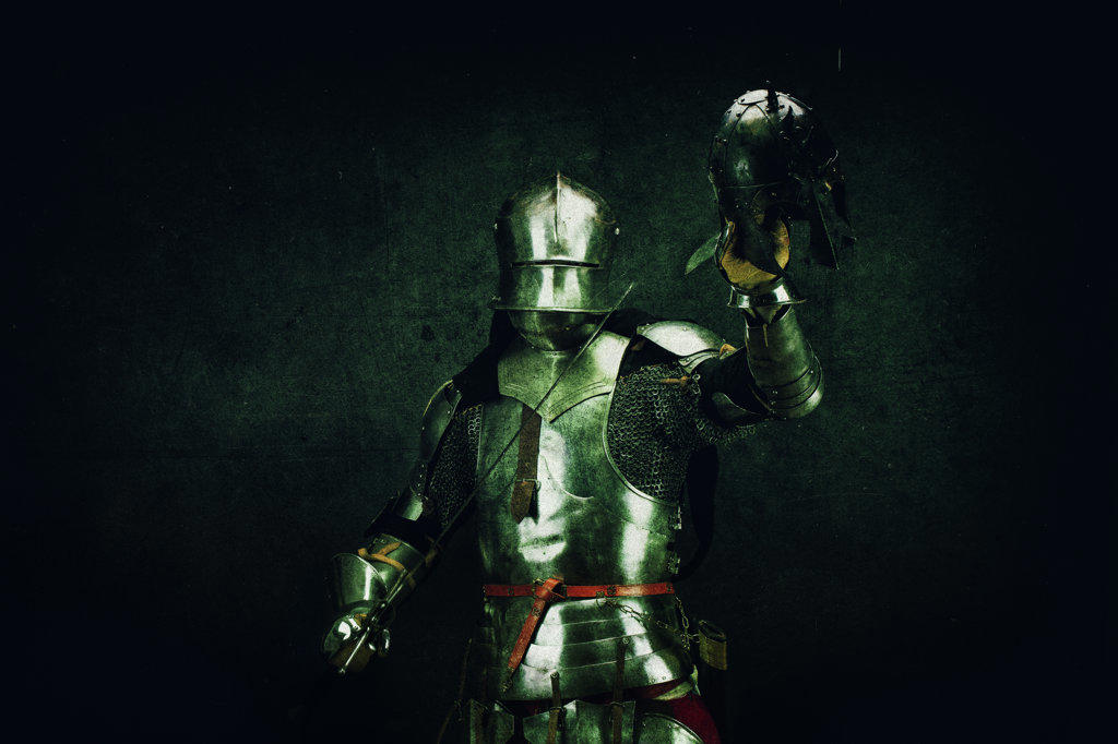 Portrait of a Knight after the battle, an enemy helmet in his hand