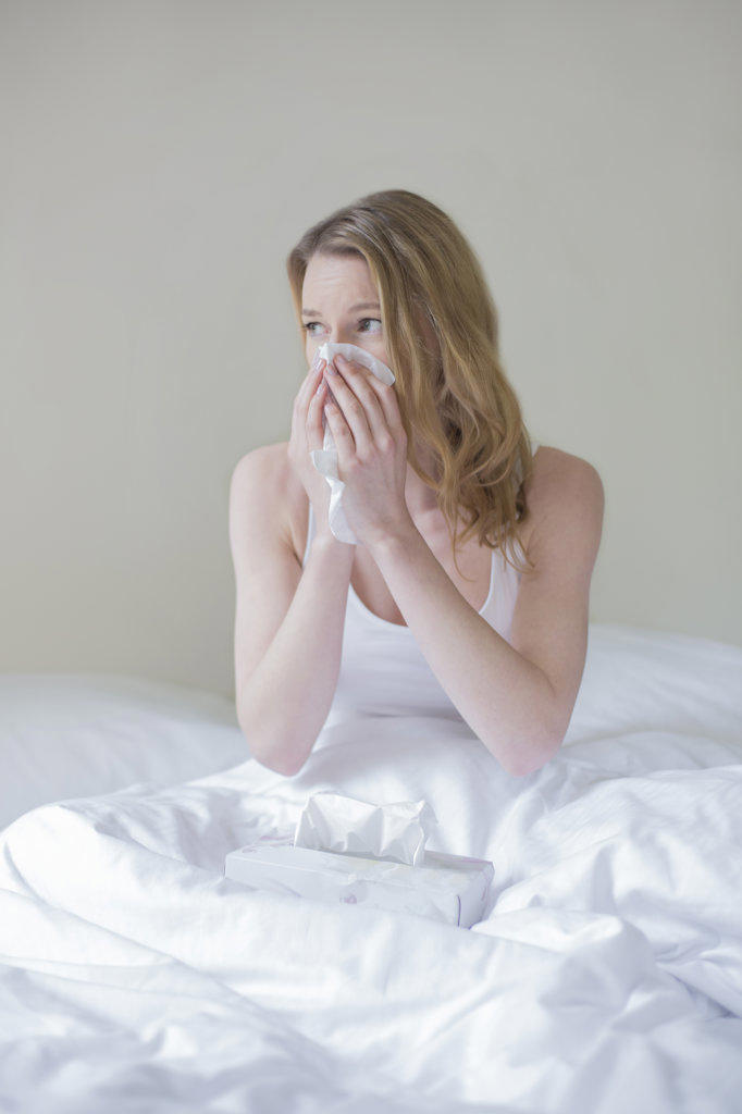 Woman sick with handkerschiefs in bed