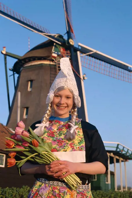 Girl Dressed in Dutch Costume in front of Windmill, Zaanse Schans, Holland (Netherlands)