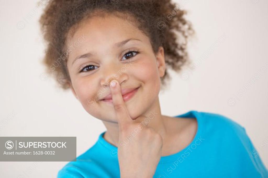 Stock Photo: 1628-0032 Portrait of a girl with her finger on her lips
