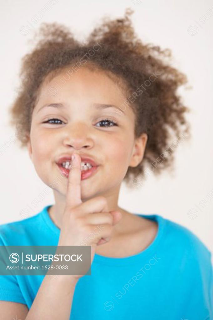 Stock Photo: 1628-0033 Portrait of a girl with her finger on her lips