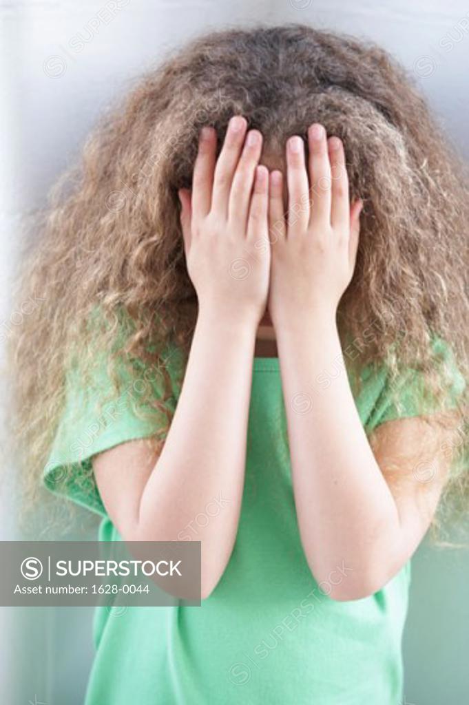 Stock Photo: 1628-0044 Close-up of a girl hiding her face with her hands