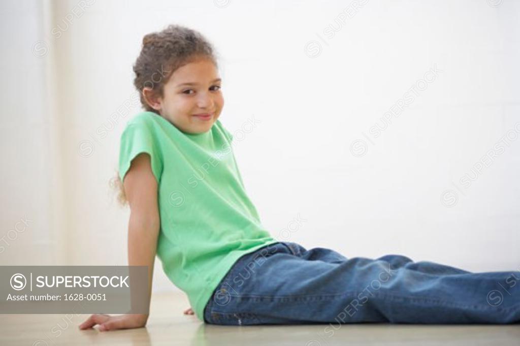 Stock Photo: 1628-0051 Portrait of a girl sitting on the floor