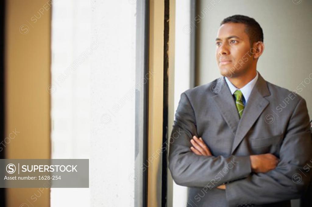 Stock Photo: 1628-254 Close-up of a businessman standing with his arms crossed