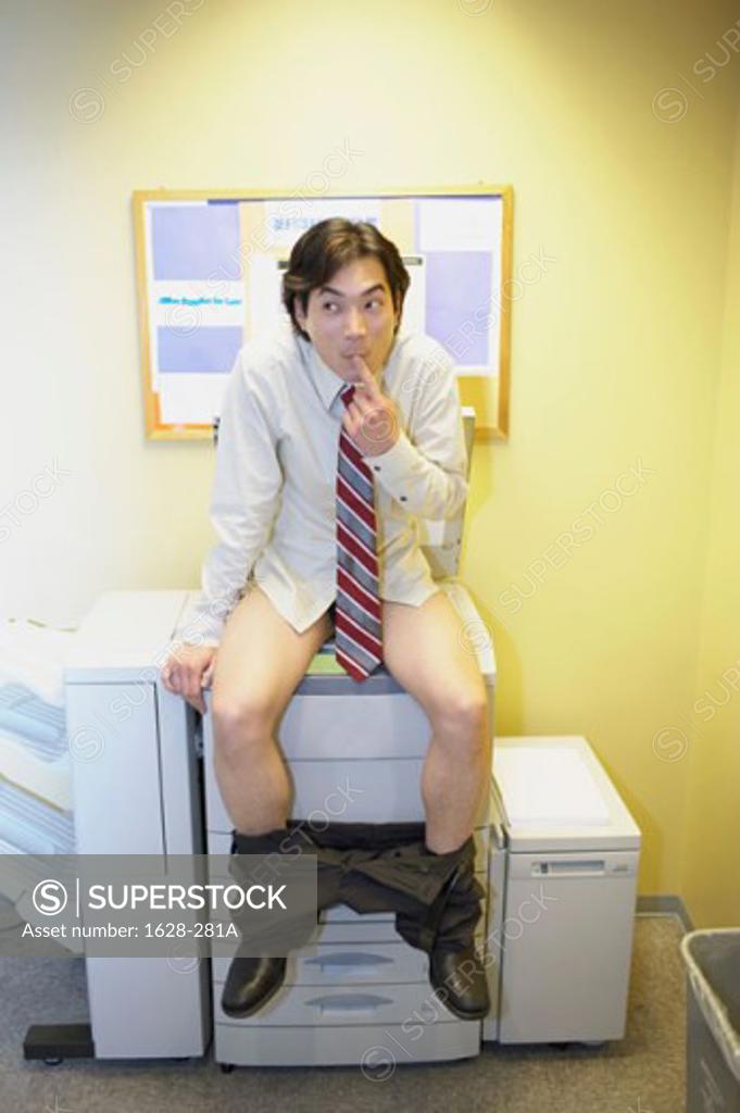 Stock Photo: 1628-281A Businessman with his pants down sitting on a photocopier