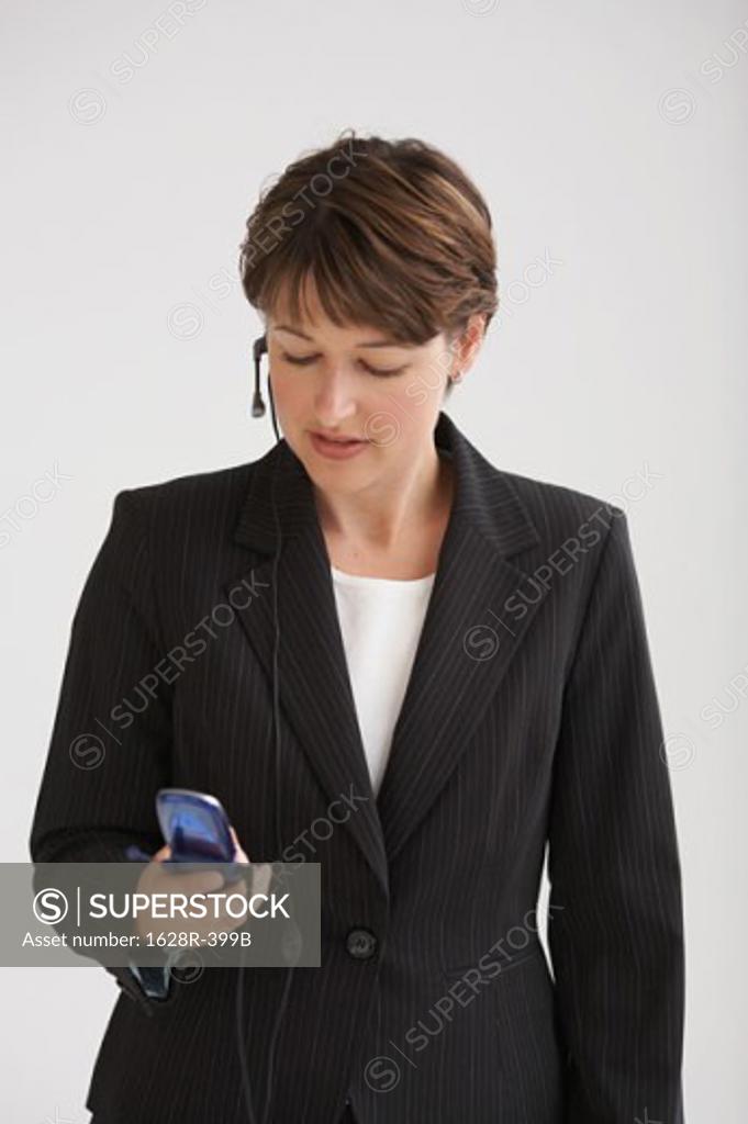 Stock Photo: 1628R-399B Close-up of a businesswoman talking on a mobile phone using a hands free device