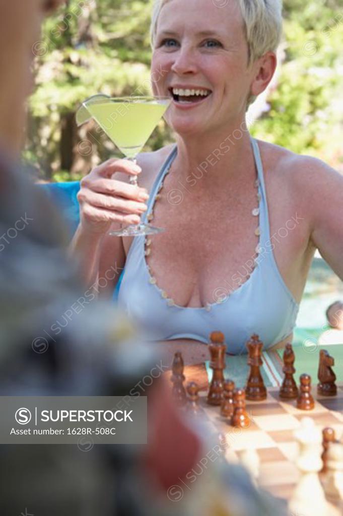 Stock Photo: 1628R-508C Close-up of a mature woman holding a martini and smiling