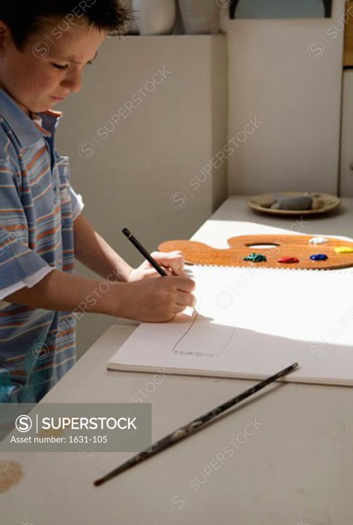 Stock Photo: 1631-105 Side profile of a boy drawing on a sketch pad