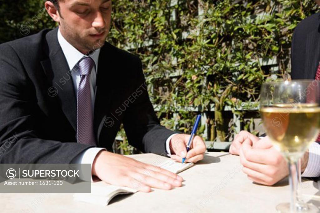 Stock Photo: 1631-120 Close-up of a businessman signing a check