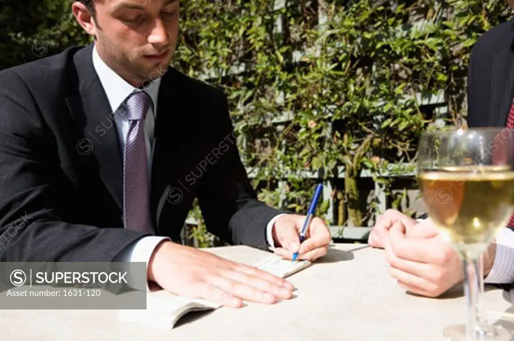 Close-up of a businessman signing a check