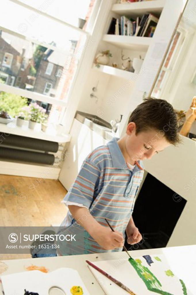 Stock Photo: 1631-134 Boy painting on a sketch pad