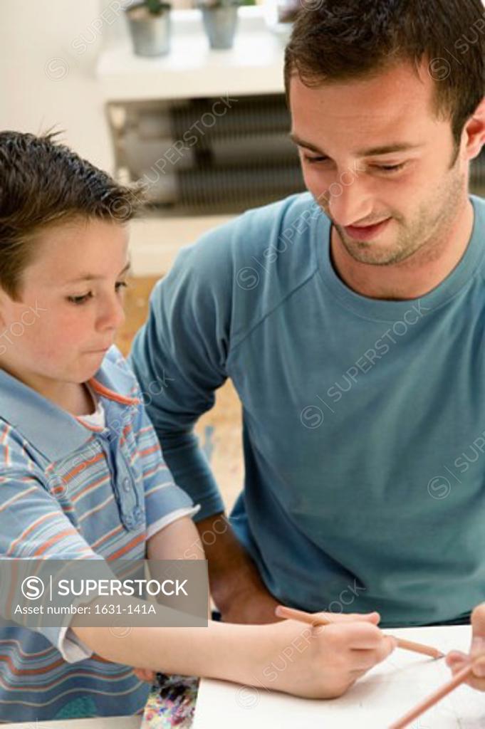 Stock Photo: 1631-141A Close-up of a boy drawing with his father