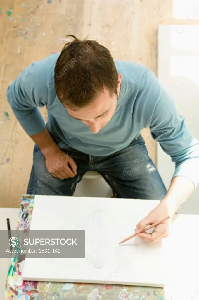 High angle view of a young man drawing