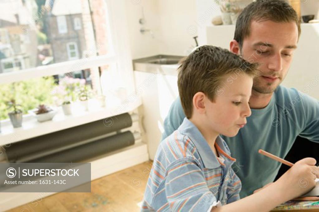 Stock Photo: 1631-143C Side profile of a boy drawing with his father