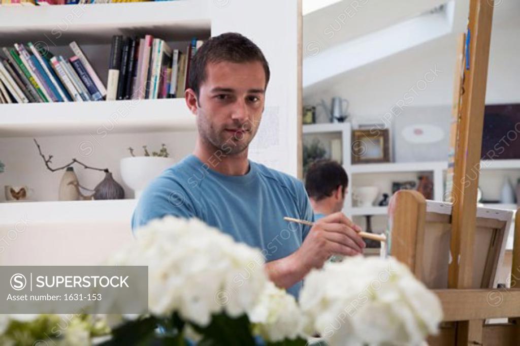 Stock Photo: 1631-153 Portrait of a young man painting on an easel
