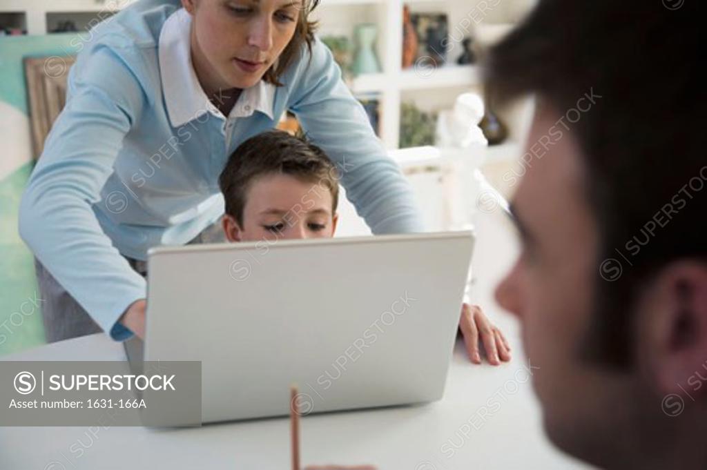 Stock Photo: 1631-166A Young woman and her son using a laptop