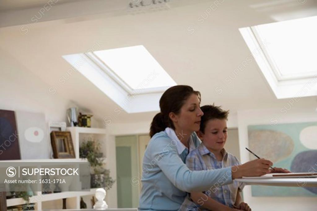 Stock Photo: 1631-171A Side profile of a young woman teaching her son to draw