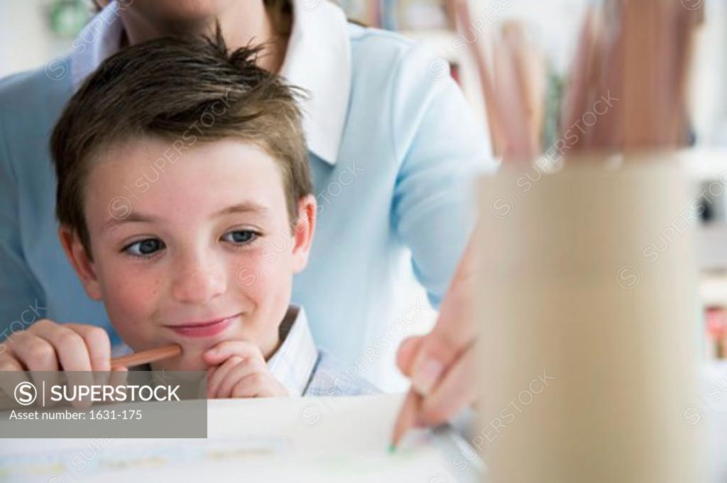 Stock Photo: 1631-175 Mid section view of a young woman teaching her son to draw