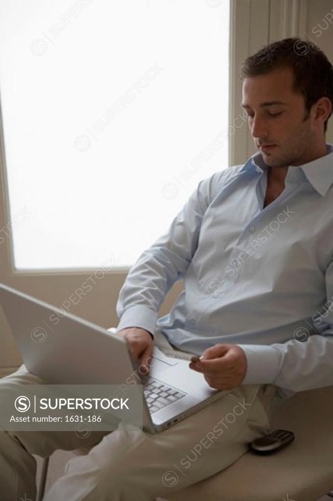 Stock Photo: 1631-186 Close-up of a young man using a laptop