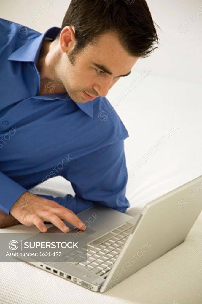 Stock Photo: 1631-197 Close-up of a young man using a laptop