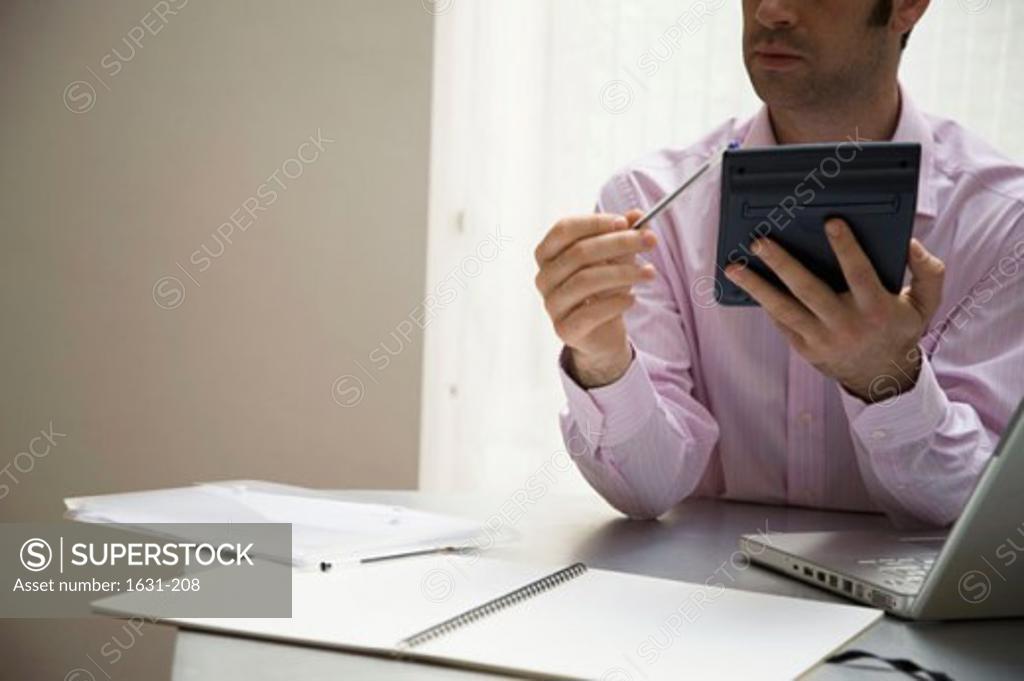 Stock Photo: 1631-208 Close-up of a businessman using an electronic organizer
