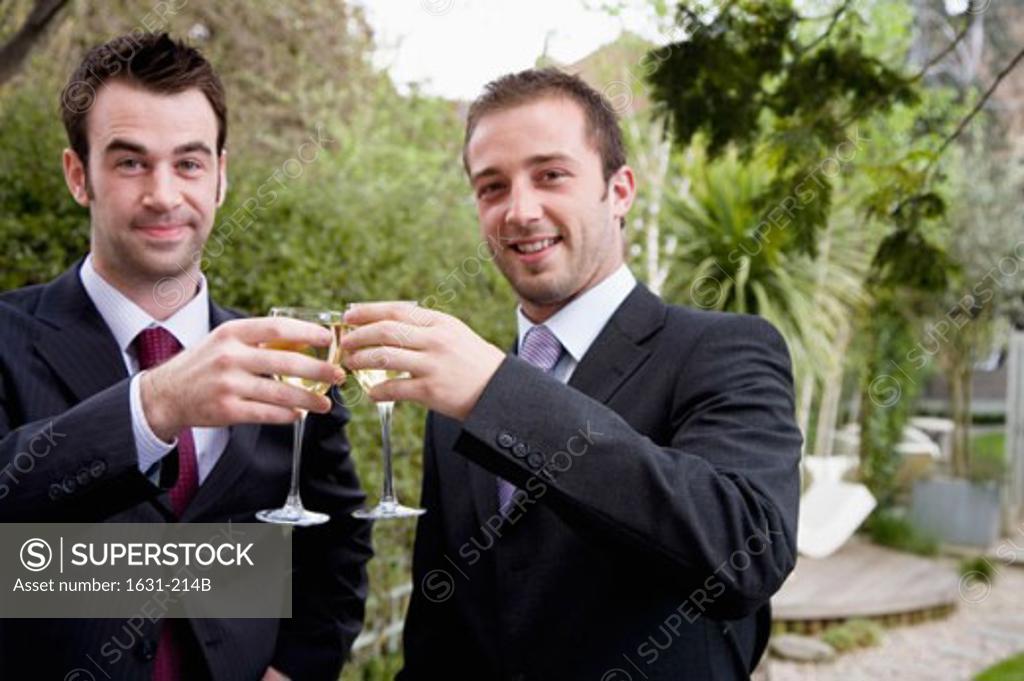 Stock Photo: 1631-214B Portrait of two businessmen toasting with wineglasses