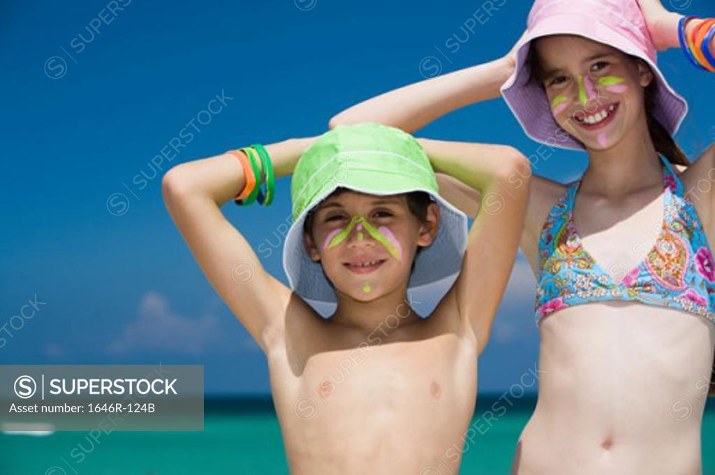 Stock Photo: 1646R-124B Portrait of a girl standing with her brother smiling