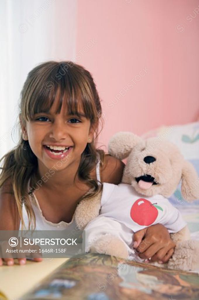 Stock Photo: 1646R-158F Portrait of a girl lying in the bed and laughing