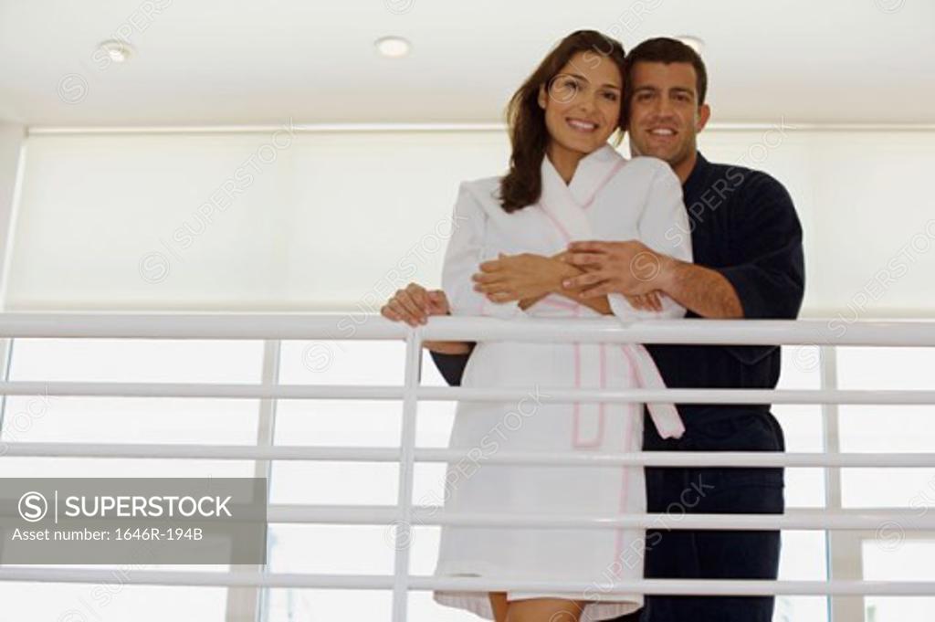 Stock Photo: 1646R-194B Portrait of a mid adult man embracing a mid adult woman and smiling